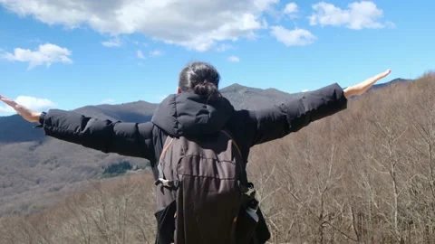 Female exploring natural environment with calm mountain lake. Stock Footage 237425438
