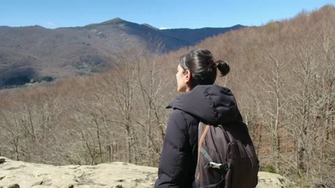 Female exploring natural environment with calm mountain lake. Stock Footage 237425443