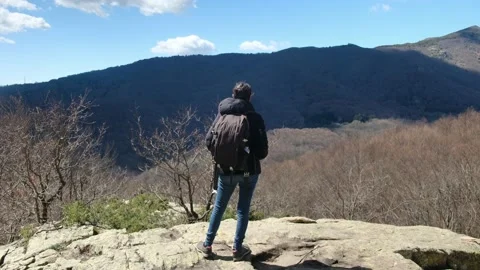 Female exploring natural environment with calm mountain lake. Stock Footage 237425464