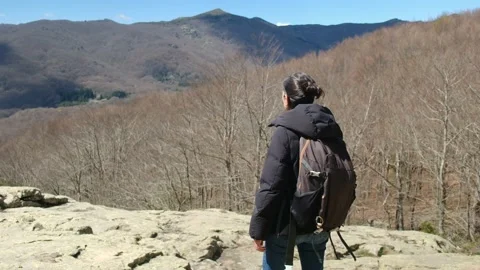 Female exploring natural environment with calm mountain lake. Stock Footage 237425474