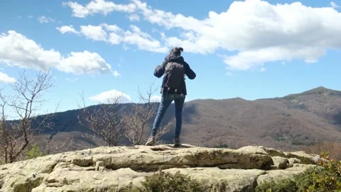 Female exploring natural environment with calm mountain lake. Stock Footage 237425491