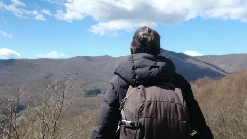 Female exploring natural environment with calm mountain lake. Stock Footage 237425509