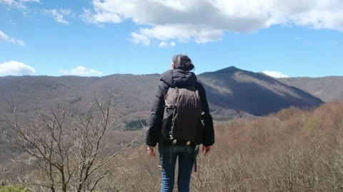 Female exploring natural environment with calm mountain lake. Stock Footage 237425512