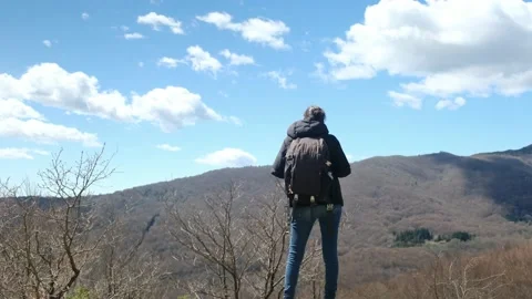 Female exploring natural environment with calm mountain lake. Stock Footage 237425520