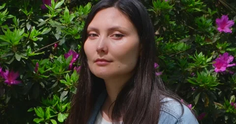 Female Face on the Background of Blooming Tree Stock Footage 200177428
