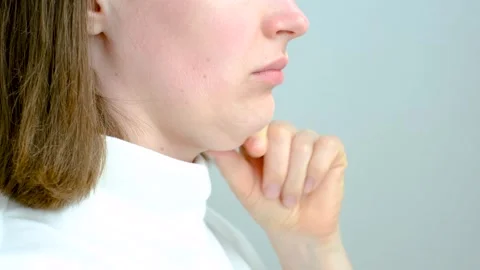 Female face with double chin close-up on gray background, side view. Stock Footage 304472545