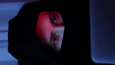 Female face looking at screen. Hacker breaks password on laptop. Vertical video Stock Footage 255252284
