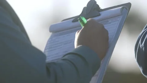 Female factory worker writing on document. Colleague standing-by Stock Footage 247484438
