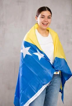 Female fan of team of country of Bosnia and Herzegovina with the national flag Stock Photos