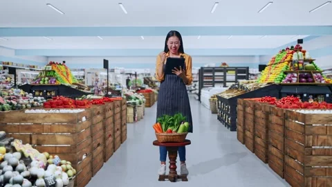 Female Farmer Celebrating Using Tablet Computer in Grocery Store Stock Footage 311233088