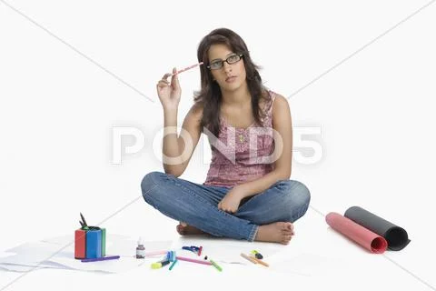 Female fashion designer sketching and thinking Stock Photos