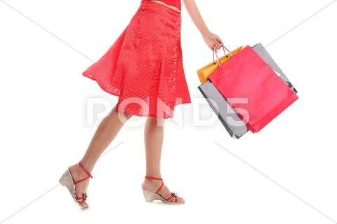 Female feet and bags with purchases Stock Photos