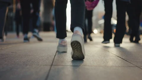 Female feet steps walking street, low angle people legs stepping zebra asphalt Stock Footage 308031253