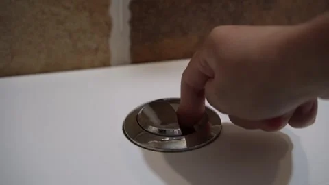 A female finger pressing flush button on toilet to flush water. Concept of sa Video stock 319616546