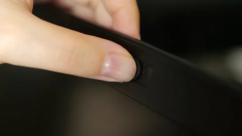 Female finger using closing webcam privacy cover slider shutter on black laptop. Stock Footage 283363744