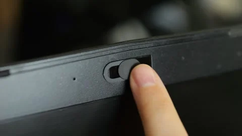 Female finger using closing webcam privacy cover slider shutter on black laptop. Stock Footage 286214689