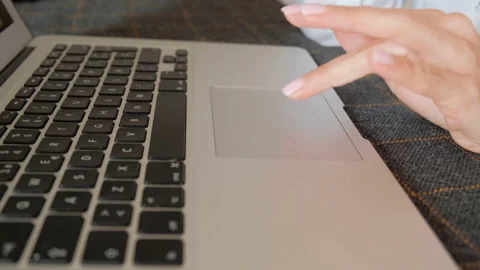 Female fingers on the keyboard and running on the touchpad Stock Footage