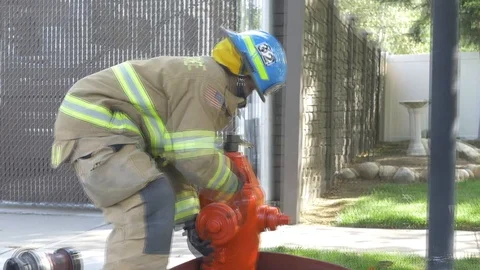 Female firefighter preparing fire hydrant for fire 4k Stock Footage 105266697