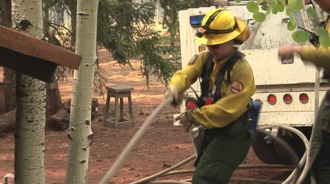 Female Firefighter pulling hose up to fire truck Stock Footage 40752716