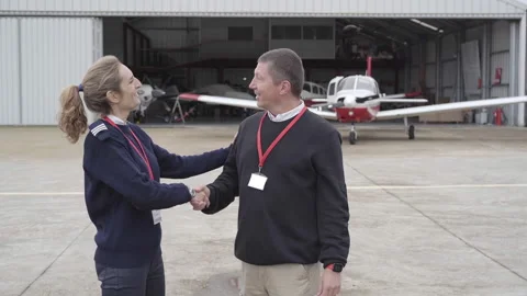 Female flight instructor congratulating her student on their first flight. Stock Footage 146375672