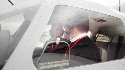Female flight instructor giving instructions to her student on the runway. Stock Footage 146375362
