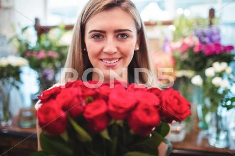 Female Florist Holding Bunch Of Rose Flowers In The Flower Shop