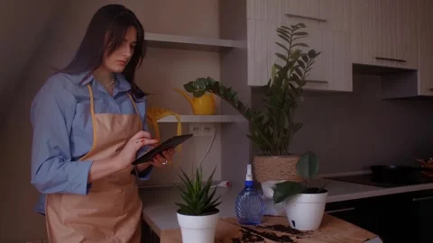 Female florist with tablet taking notes about plants, gardening Concept of digit Stock Footage 266142142