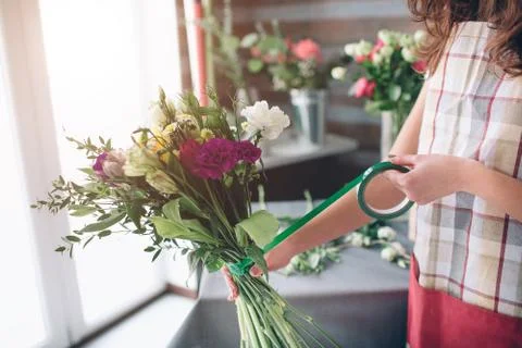 Female florist at work: pretty young dark-haired woman making fashion modern  Stock Photos