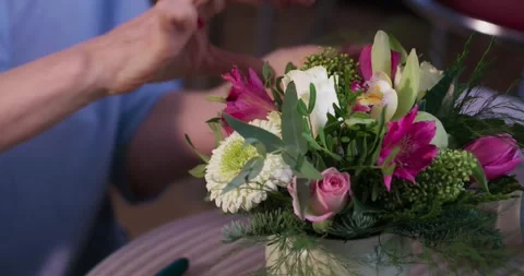Female florist's hands remove extra petals from bud of flower. Close-up of 스톡 동영상 278037131