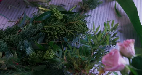 Female florist's hands remove extra petals from bud of flower. Close-up of Video stock 278037495