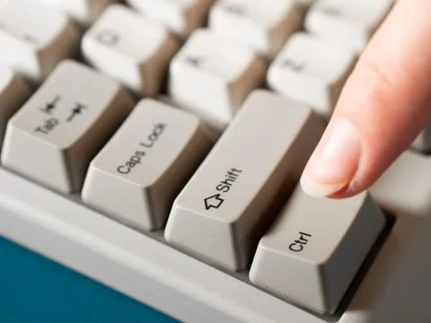 Female forefinger pushes LEFT CTRL button. Close-up Stock Photos