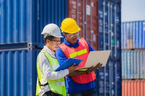 Female foreman using clipboard checklist and Worker man holding laptop control Stock Photos