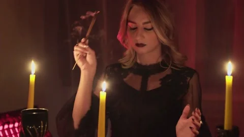 Female fortune teller lights magic incense for paranormal ritual Video stock 140816009