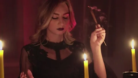 Female fortune teller lights magic incense for paranormal ritual Stock Footage 143506997