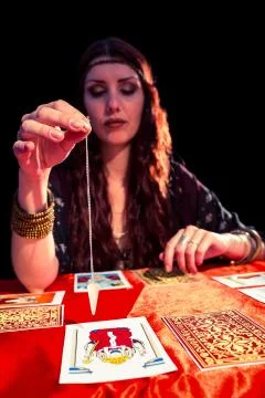 Female fortune teller using pendulum Foto stock