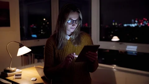 Female free lance worker working late at night finishing assignments working on Stock Footage 149029252