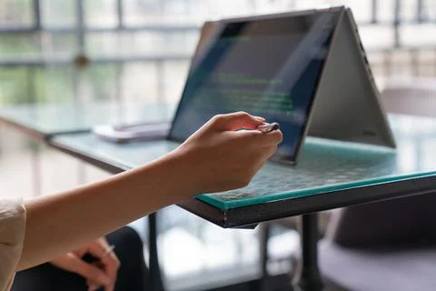 Female freelance developer coding and programming. Coding on two with screens Stock Photos