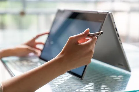 Female freelance developer coding and programming. Coding on two with screens Stock Photos