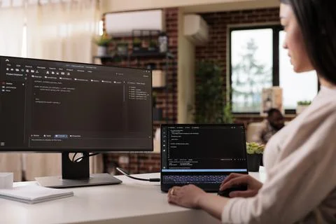 Female freelance developer coding html script Stock Photos