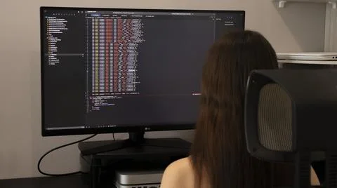 Female freelance programmer writes javascript project program for mobile app. Stock Photos