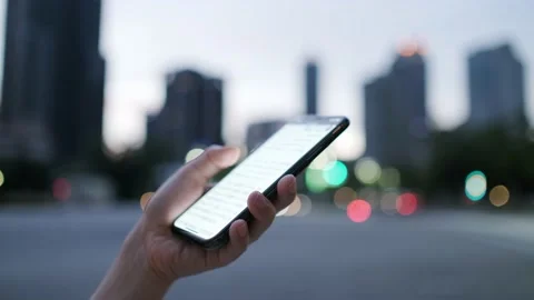 Female freelance worker using smartphone outdoors Stock Footage 195095499