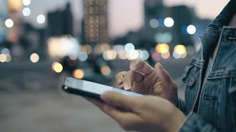 Female freelance worker using smartphone outdoors Stock Footage 195096099