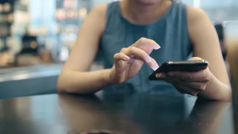 Female freelance worker using smartphone Stock Footage 195096162