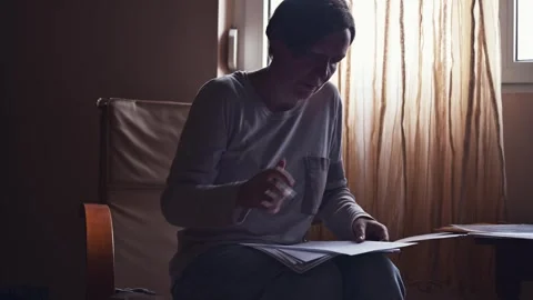 Female freelancer doing paperwork in home office interior, 4K Stock Footage 293488228