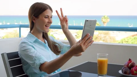 Female freelancer doing selfie on mobile phone. Woman on vacation using smart Stock Footage 99059019