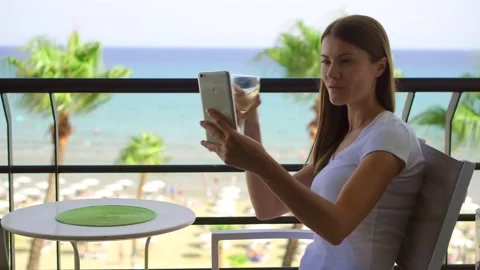 Female freelancer doing selfie on mobile phone. Woman on vacation using smart Stock Footage 143547089