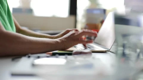 Female freelancer typing on laptop computer while working from home Видео 220038606