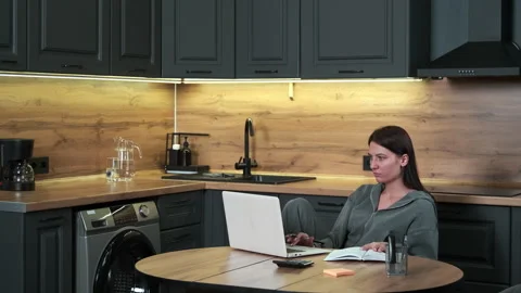 Female freelancer uses laptop while working from home. Stock Footage 301655631
