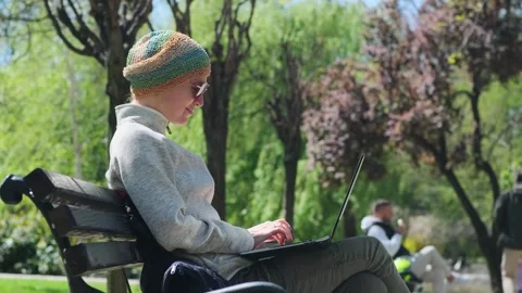 Female freelancer using her computer outdoor. Stock Footage 255207500