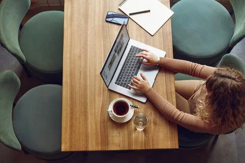 Female freelancer using laptop for work at cafe Stock Photos
